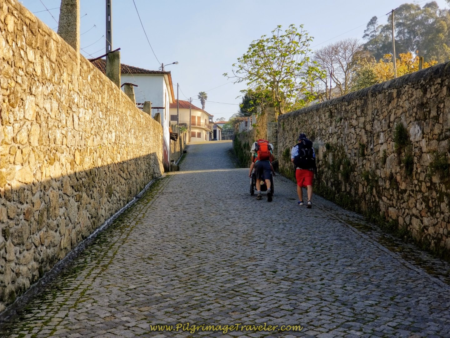 Rich Pushing Magdalena Up the Cobblestone Rua Dom Zameiro, Ponte do Ave, Portugal on the Central Route of the Camino Portugués