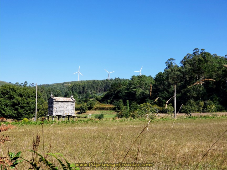 Quaint Hórreo in a Field with Windmills Near Dumbría