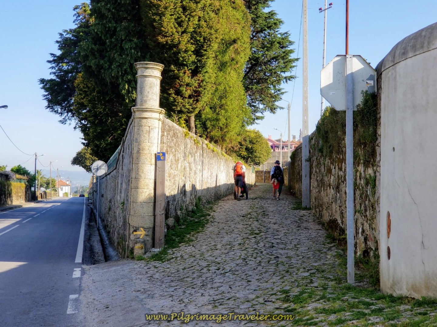 Rich Pushes Magdalena Thru São Mamede on Cobblestone Street on day sixteen on the Central Route of the Camino Portugués