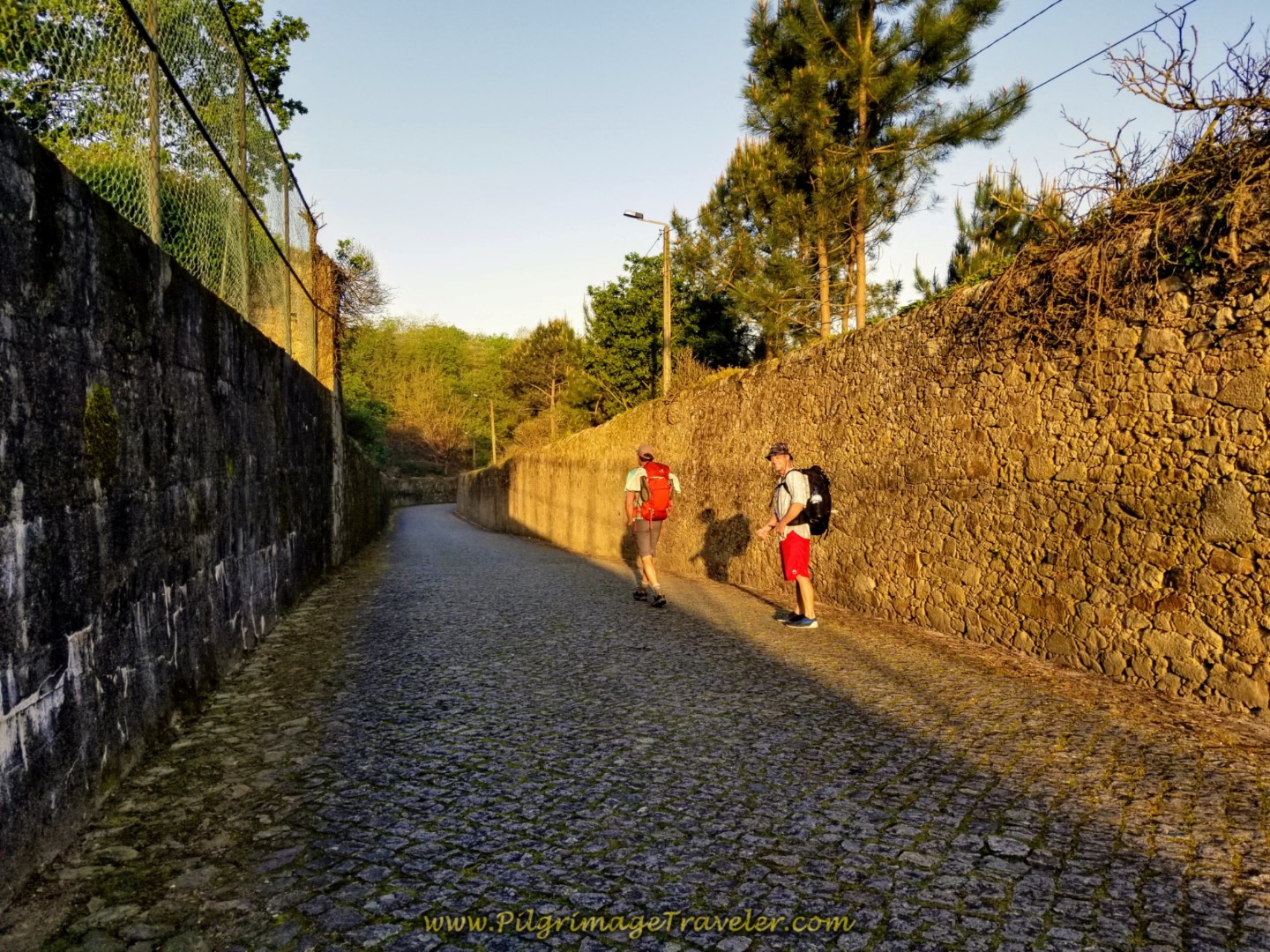 Rich and Matt Setting off on the cobblestone of the Rua de São Bento, in Vilarinho Portugal on the Central Route of the Camino Portugués