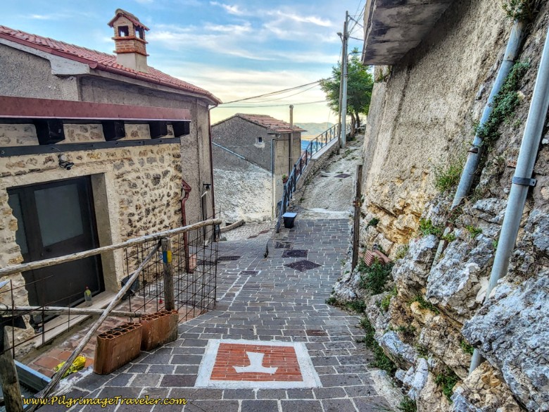 Way of St. Francis: Day Eighteen, Poggio Bustone to Rieti - Painted Tau Waymark on the Pavement, Poggio Bustone