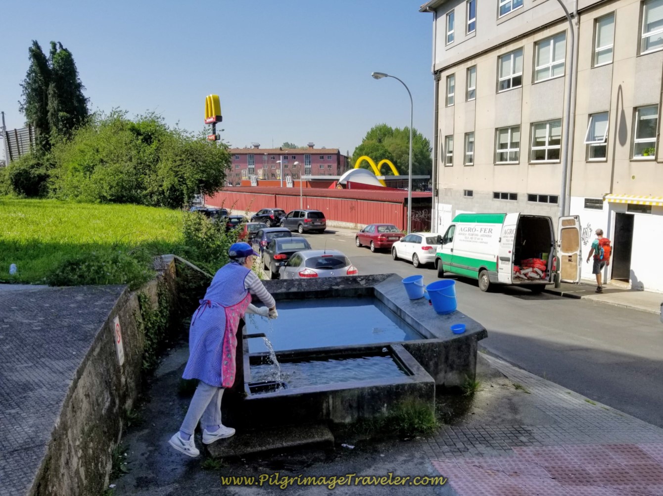 Woman Washing Clothes By Hand at Fountain in the City on day eight of the English Way Woman Washing Clothes By Hand at Fountain in the City on day eight of the English Way