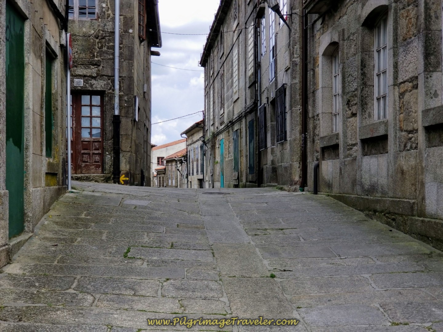 Walking Up the Rúa Piñeiro in Tui, toward the cathedral on day nineteen on the Central Route of the Portuguese Camino Walking Up the Rúa Piñeiro in Tui, toward the cathedral on day nineteen on the Central Route of the Portuguese Camino
