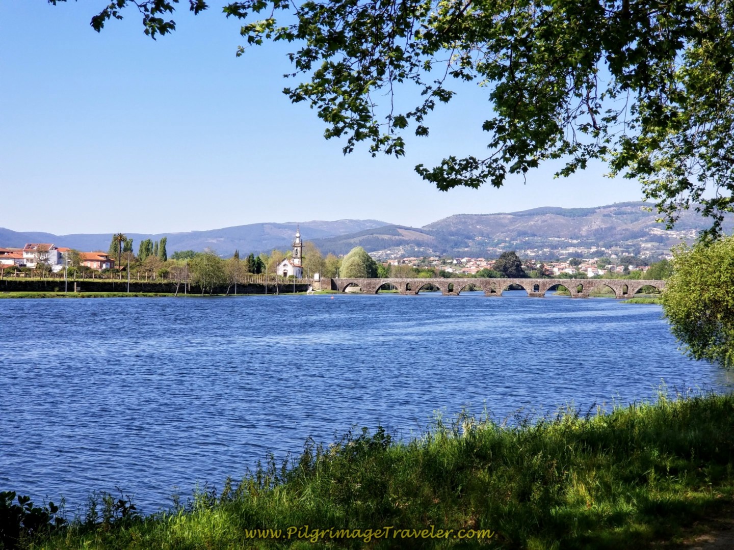 First Glimpse of the Medieval Bridge and the Igreja de Santo António da Torre Velha in Ponte de Lima on day seventeen on the Central Route of the Portuguese Camino