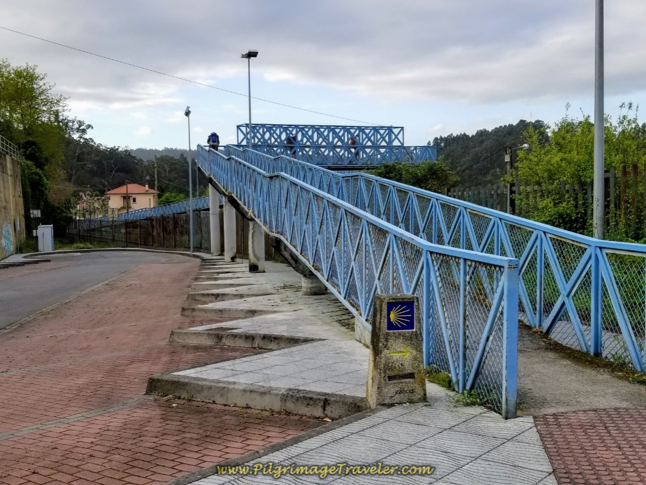 Camino Takes the Blue Pedestrian Bridge Across the Railroad tracks on day four of the Camino Inglés