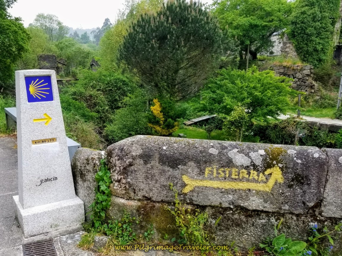 Painted Fisterra Sign on Ponte Sarela at Kilometer Marker 89.17 on day one of the Camino Finisterre