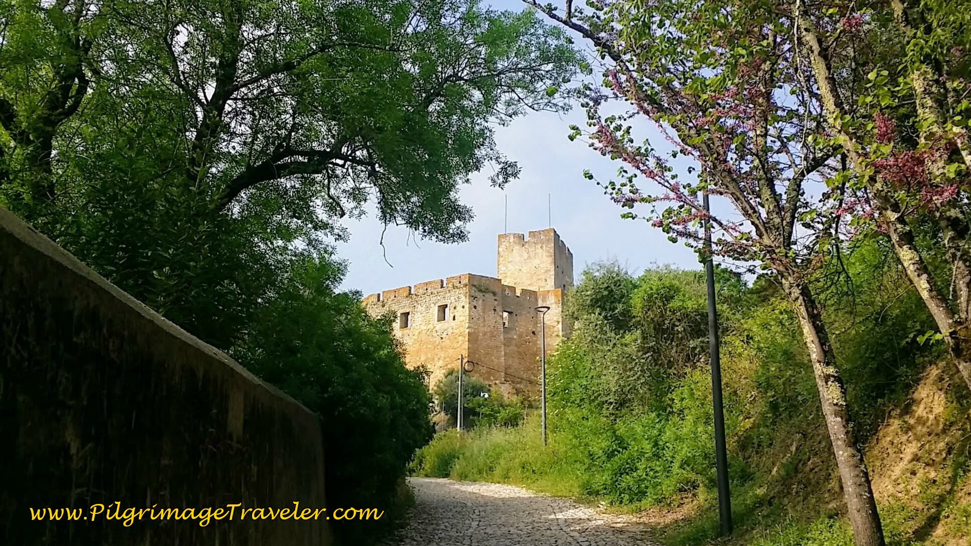 First Glimpse of Rampart Walls on cobblestone path, Tomar